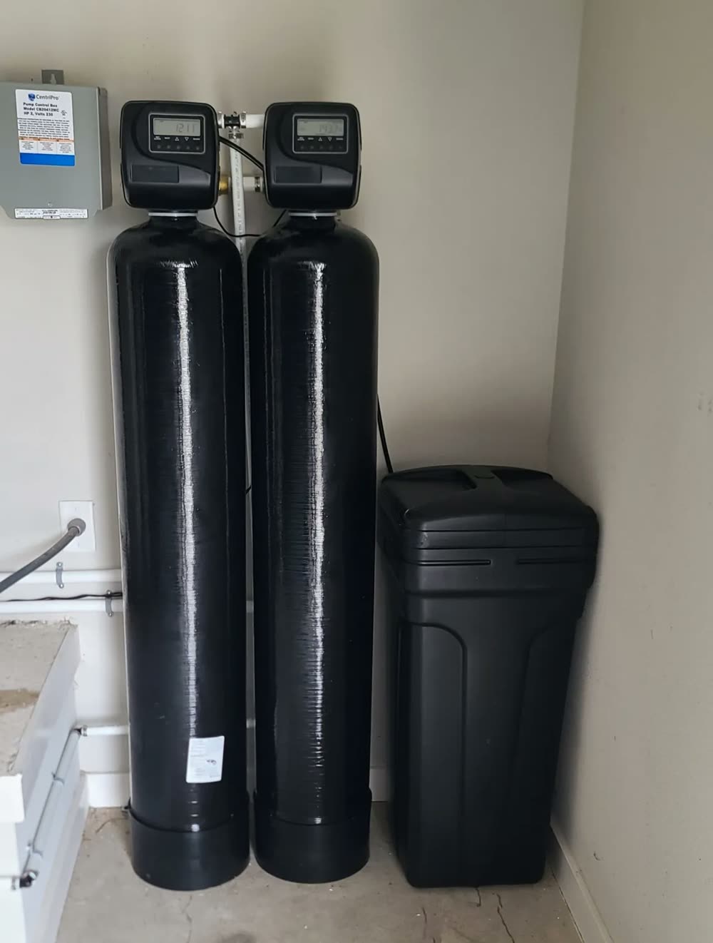 Dual-tank water filtration system installed in an Orange County garage